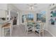 Bright breakfast nook features tile floors, glass table, and view of the lanai at 934 Rotonda Cir, Rotonda West, FL 33947