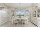 Elegant dining room with large windows, stylish chandelier, and white china cabinet at 934 Rotonda Cir, Rotonda West, FL 33947