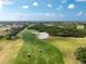 Aerial view of lush golf course with meticulously maintained greens and sand traps under a sunny sky at 934 Rotonda Cir, Rotonda West, FL 33947