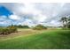 Lush green golf course with well-maintained grass, sand hazards and native foliage at 934 Rotonda Cir, Rotonda West, FL 33947