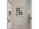 Hallway view with decorative niche and doorway leading to a bathroom with vanity and shower at 934 Rotonda Cir, Rotonda West, FL 33947