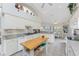 Bright kitchen with white cabinets, an island, and a view into the cozy breakfast nook at 934 Rotonda Cir, Rotonda West, FL 33947