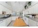 Bright kitchen featuring white cabinets, a central island, and an open layout to the breakfast nook at 934 Rotonda Cir, Rotonda West, FL 33947