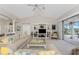 Bright living room featuring neutral tones, comfortable seating, and a view of the outdoor pool area at 934 Rotonda Cir, Rotonda West, FL 33947