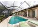 Relaxing screened-in pool area with lounge chairs and outdoor seating in a partially covered lanai at 934 Rotonda Cir, Rotonda West, FL 33947