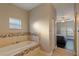 Bathroom with large soaking tub and access to bedroom at 1314 E Knollwood St, Tampa, FL 33604