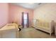 Charming Bedroom with crib, dresser, and butterfly wallpaper at 1314 E Knollwood St, Tampa, FL 33604