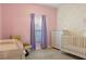 Charming Bedroom with crib, dresser, and butterfly wallpaper at 1314 E Knollwood St, Tampa, FL 33604