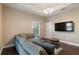 Living room with sectional sofa, wood floors, and a flat-screen TV at 1314 E Knollwood St, Tampa, FL 33604