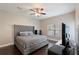 Main bedroom with king-size bed, dark hardwood floors, and large window at 1314 E Knollwood St, Tampa, FL 33604