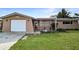 Single-story house with a single-car garage and neat landscaping at 5810 8Th Ave, New Port Richey, FL 34652