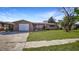 House with a single-car garage and a neatly kept lawn at 5810 8Th Ave, New Port Richey, FL 34652