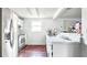 White kitchen with stainless steel appliances and wood floors at 5810 8Th Ave, New Port Richey, FL 34652