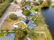 Aerial view showcasing home, pool, and lakefront location at 12321 Smokey Dr, Hudson, FL 34669