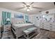 Main bedroom with a king-size bed and light wood furniture at 12321 Smokey Dr, Hudson, FL 34669