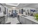 Modern kitchen with gray cabinets, marble countertops, and stainless steel appliances at 12321 Smokey Dr, Hudson, FL 34669