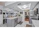 Bright kitchen featuring gray cabinetry, marble flooring, and an island at 12321 Smokey Dr, Hudson, FL 34669