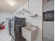 Bright laundry room with washer, dryer, and utility sink at 12321 Smokey Dr, Hudson, FL 34669