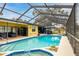 Large screened-in pool and spa with lake view at 12321 Smokey Dr, Hudson, FL 34669