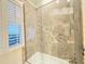 Bathroom with glass enclosed tub and shower at 1108 Bayhead Ln, Osprey, FL 34229