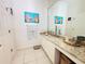 Bright bathroom, granite countertop, and large mirror at 1108 Bayhead Ln, Osprey, FL 34229