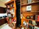 Built-in wooden bookshelves with various books and decorative items at 1108 Bayhead Ln, Osprey, FL 34229