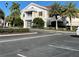 Exterior of community building with palm trees and parking at 1108 Bayhead Ln, Osprey, FL 34229