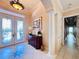 Elegant entryway with double doors, columns, and a decorative console table at 1108 Bayhead Ln, Osprey, FL 34229