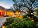 Evening view of home exterior with festive landscaping at 1108 Bayhead Ln, Osprey, FL 34229