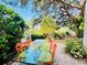 Relaxing patio with seating area and lush tropical landscaping at 1108 Bayhead Ln, Osprey, FL 34229