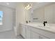 Modern bathroom featuring a double vanity with marble countertops and black faucets at 9039 Duany Ln, Lakewood Ranch, FL 34240