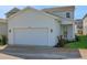 Charming house exterior showcasing a two-car garage and manicured lawn at 9039 Duany Ln, Lakewood Ranch, FL 34240