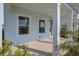 Light blue front porch with white pillars and green shrubs at 9039 Duany Ln, Lakewood Ranch, FL 34240