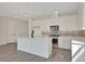 Bright kitchen features white cabinets, stainless steel appliances, and a center island with a black faucet at 9039 Duany Ln, Lakewood Ranch, FL 34240