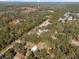 Aerial view of wooded property featuring buildings and a large paved parking area at 2044 Culbreath Rd, Brooksville, FL 34601
