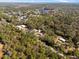 An aerial view reveals the property, surrounded by a rich tapestry of trees and vegetation at 2044 Culbreath Rd, Brooksville, FL 34601