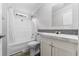 Updated bathroom with a shower over tub and stylish vanity with marble countertop at 2044 Culbreath Rd, Brooksville, FL 34601
