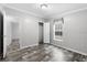 Bright bedroom with wood-look flooring, window and view to the hallway and closet at 2044 Culbreath Rd, Brooksville, FL 34601