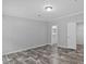 View of a bedroom with wood-look floors and an open doorway leading to a walk-in closet at 2044 Culbreath Rd, Brooksville, FL 34601