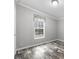 Light-filled bedroom with a neutral color palette and attractive wood-look floors at 2044 Culbreath Rd, Brooksville, FL 34601