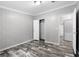 Bedroom features wood-look flooring and a doorway to bathroom and closet at 2044 Culbreath Rd, Brooksville, FL 34601