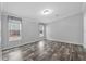 Bright bedroom with two large windows, wood-look flooring, and neutral wall colors at 2044 Culbreath Rd, Brooksville, FL 34601