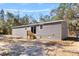 This manufactured home has gray siding and an entrance door at 2044 Culbreath Rd, Brooksville, FL 34601