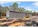 A manufactured home featuring gray siding, a new front door, and a clean landscape at 2044 Culbreath Rd, Brooksville, FL 34601