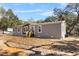 Lovely single Gathering home with gray siding, a inviting front entrance, and lush surrounding trees at 2044 Culbreath Rd, Brooksville, FL 34601