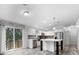 Modern kitchen with stainless steel appliances, a center island, and sliding door access to the deck at 2044 Culbreath Rd, Brooksville, FL 34601