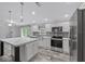 Spacious kitchen featuring stainless appliances, a large island, and bright lighting at 2044 Culbreath Rd, Brooksville, FL 34601