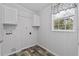 The laundry room includes overhead cabinets and a window for natural light at 2044 Culbreath Rd, Brooksville, FL 34601