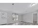 Bright living area with neutral walls, stylish flooring, and a clear view of the front door and windows at 2044 Culbreath Rd, Brooksville, FL 34601