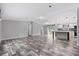 Open-concept living space with modern flooring flowing into a bright kitchen with a center island at 2044 Culbreath Rd, Brooksville, FL 34601